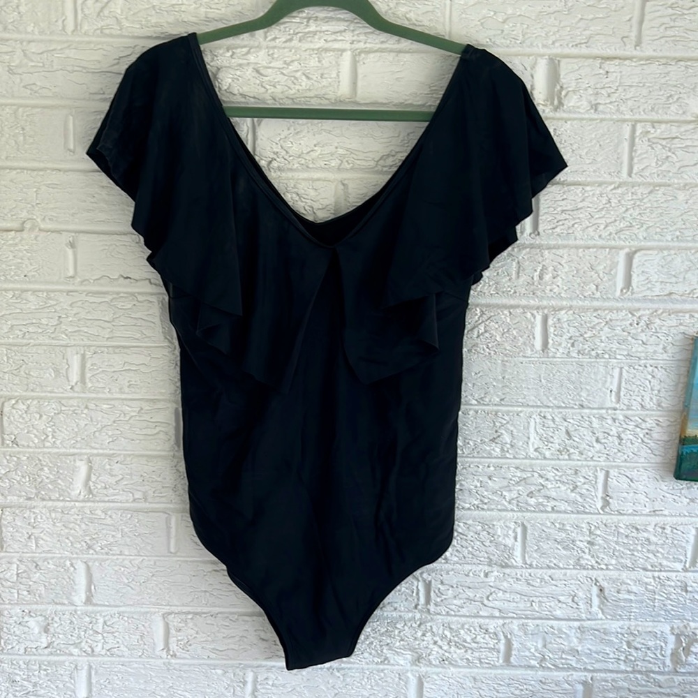 Black 1 pc swimsuit with draped sleeve around whole b neckline